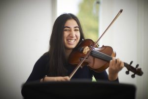 female student playing violin