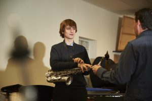 teenage boy having a music lesson, holding a trumpet