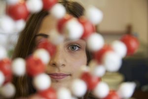 Student behind a DNA display