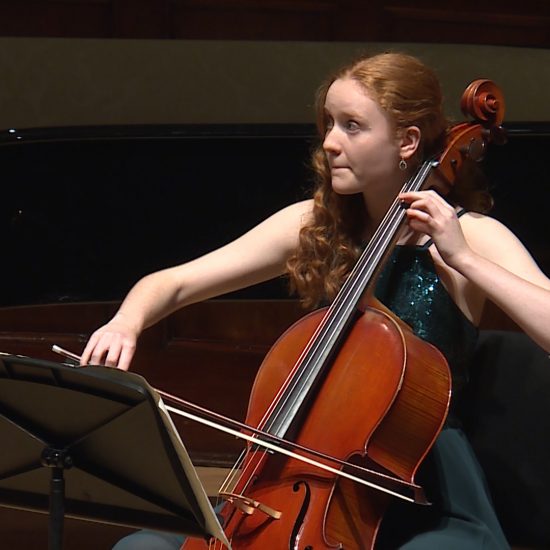 girl in formal dress playing cello