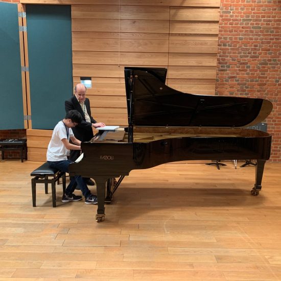 young boy playing piano