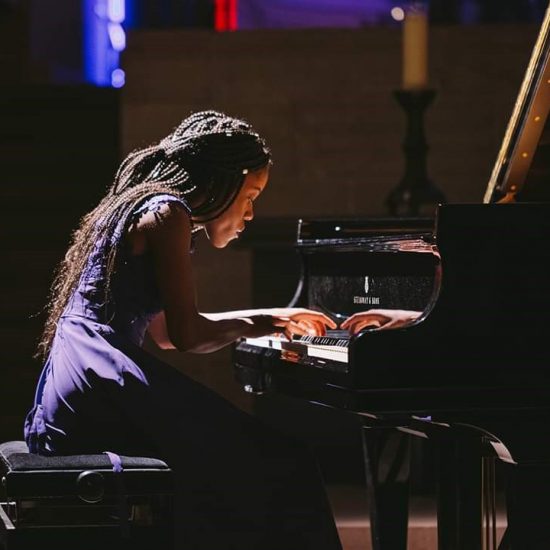 teenage girl performing piano