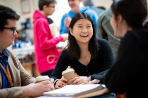 smiling students drinking coffee