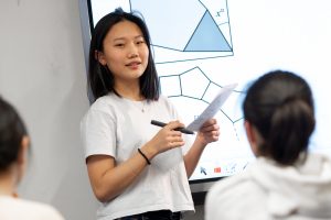 girl standing in front of an interactive whiteboard