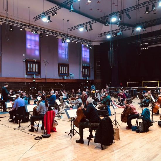 group of musicians in a large hall